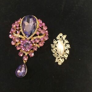 2 brooches. Large gold with faux amethyst stones. Small pearl in silver setting.